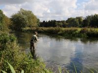 Charles Jardine wading the river.