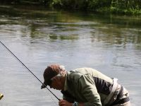 Charles Jardine releasing a Brown Trout.