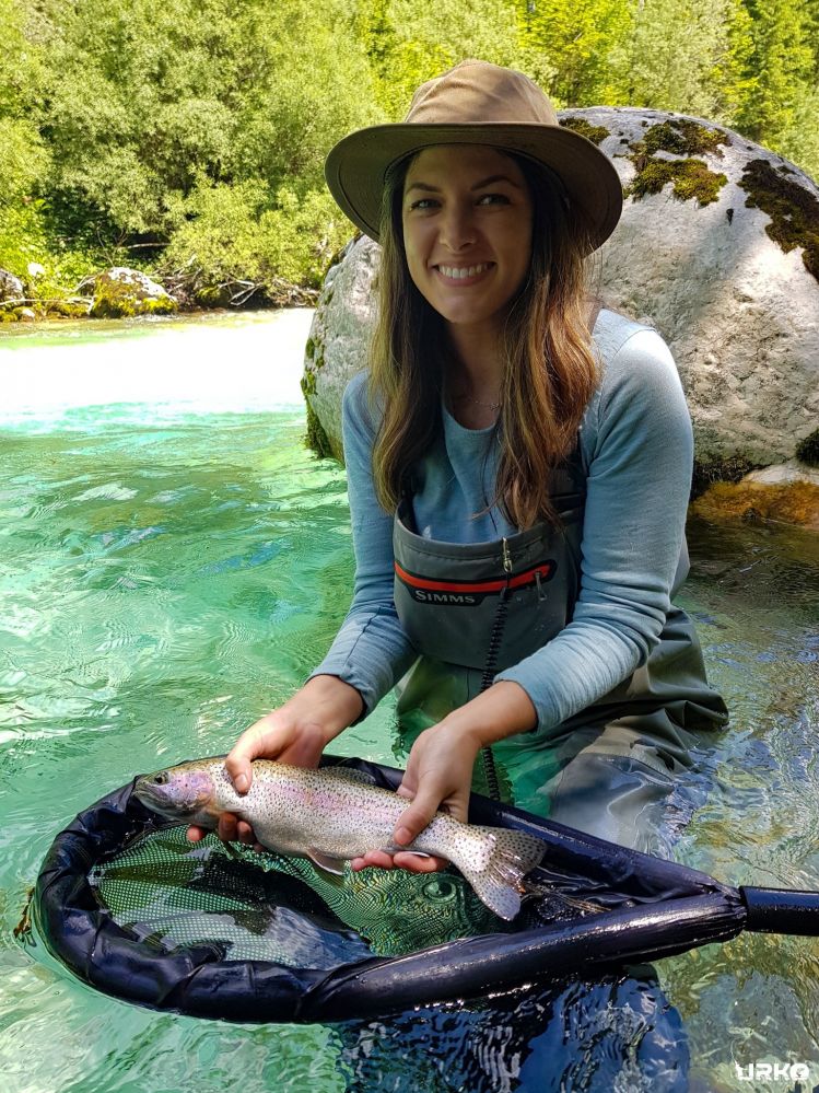 Stacy with her lovely rainbow trout from the river Soča. 