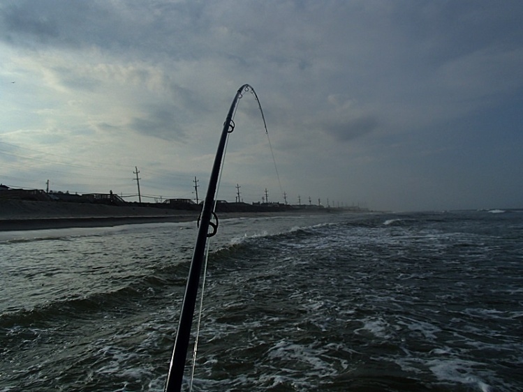 Standing on the second bar fishing toward the beach with a hard running high tide.  Drama!